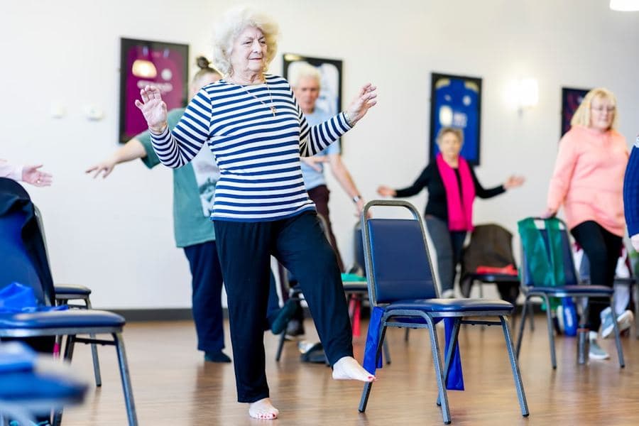 Community dance class in a bright hall
